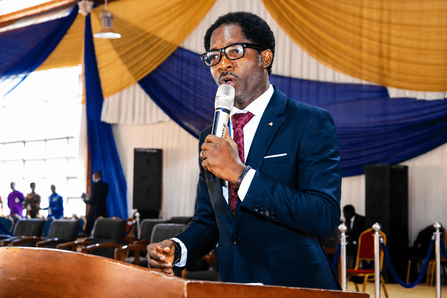 Dr. Temitope Ebenezer Arowele speaking on stage